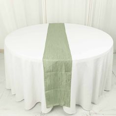 a round table with a green and white runner