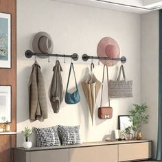 there are many hats and purses hanging on the wall next to each other in this room