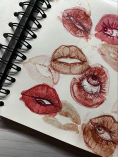 an open notebook with lipstick drawn on it