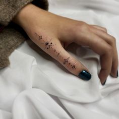 a woman's hand with a tattoo on it