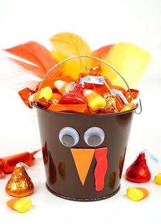 a bucket filled with candy and a turkey face