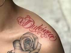 a woman's chest with a rose tattoo and the word believe written on it