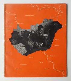 an orange book with black and white images on it's cover is shown in the shape of a map