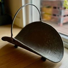 a metal bucket sitting on top of a wooden floor next to a sliding glass door