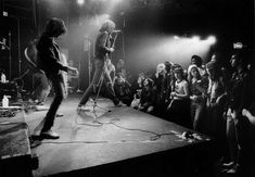 a group of people standing on top of a stage with microphones in front of them