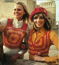 two women in crocheted clothing posing for the camera