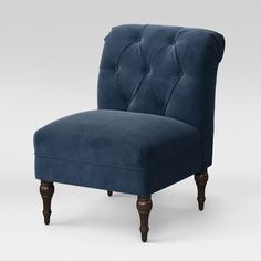 an upholstered chair with wooden legs and dark blue fabric, against a white background