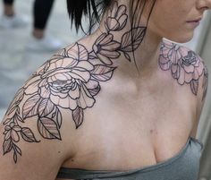 a woman's neck with flowers on it