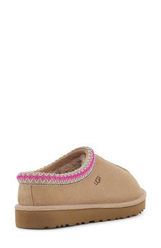 A warm, suede slipper with embroidered trim and a plush genuine-shearling lining can be worn in or out of the house thanks to the grippy sole. Slight dye transfer may occur with darker colors during first few wears Leather upper/genuine-shearling or genuine-shearling and UGGpure wool lining/rubber sole Shearling may be sourced from Australia, Ireland, Spain, the UK or the USA. See packaging for confirmed country of origin UGGpure, a moisture-wicking textile made entirely from wool but crafted to Cute Uggs, Ugg Tasman Slippers, Preppy Shoes, Pretty Shoes Sneakers, Ugg Tasman, Cute Slippers, Cute Nike Shoes, Embroidered Trim, Girly Shoes