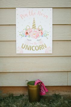 a sign that says run the horse, unicorn on it next to a bucket with flowers