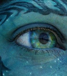 an image of a person's eye with blue paint on it