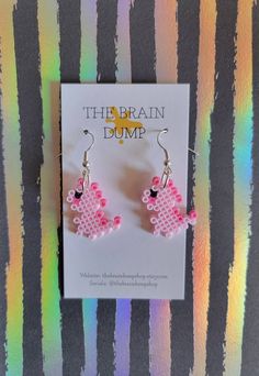 the brain dump earrings are pink and black