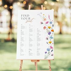 an easel with a floral seating plan on it