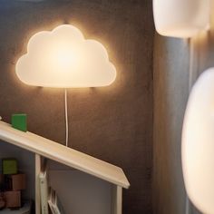 a lamp that is on top of a shelf next to a bookcase and books