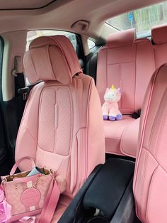 the interior of a pink car with stuffed animals in it's seat covers and other accessories