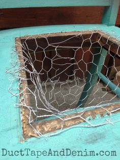 an old window is covered in wire and wood