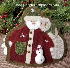 a christmas ornament with a snowman and santa clause on it's back