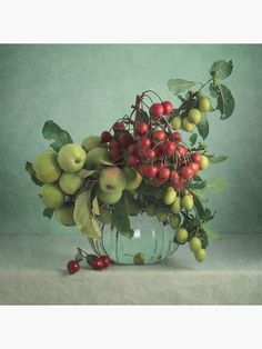 a vase filled with lots of fruit on top of a table