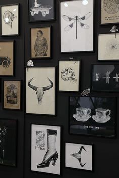 a black wall with pictures and drawings on it