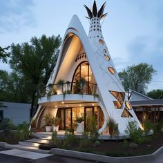 a very unusual house that is in the shape of a pyramid with plants growing out of it