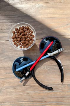 a bowl of dog food and a pair of scissors on a wooden table