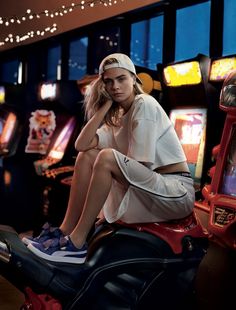 a woman sitting on top of a motorcycle next to slot machines