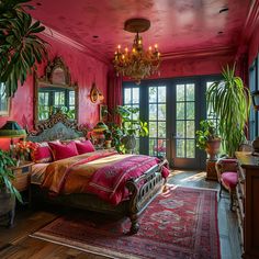 a bedroom decorated in pink and gold with potted plants on either side of the bed