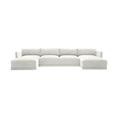 a white sectional couch sitting on top of a white floor