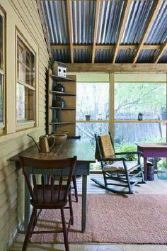 a rocking chair sitting on top of a wooden floor next to a table and chairs