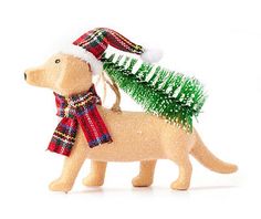 a toy dog with a christmas tree on its back