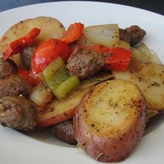 a white plate topped with meat and veggies