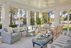 a living room filled with furniture and lots of windows