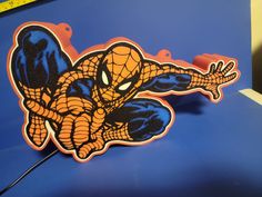 a spider man sticker on the hood of a car