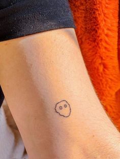 a person with a small tattoo on their arm