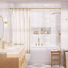 a bathroom with white tile and gold fixtures