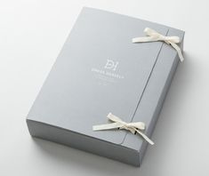 an open box with ribbon tied around it