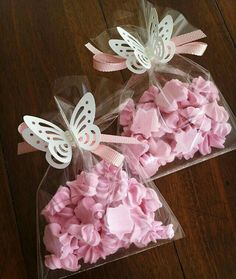 two bags filled with pink marshmallows sitting on top of a wooden floor