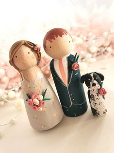 a wooden figurine of two people and a dog sitting next to each other