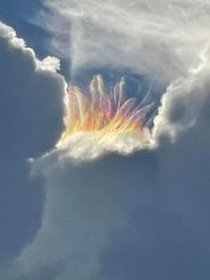 an image of a rainbow in the clouds that looks like it's going to fall