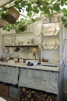 an old fashioned kitchen with pots and pans hanging from the ceiling