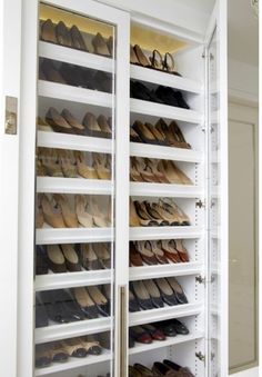 an open closet with many pairs of shoes in it