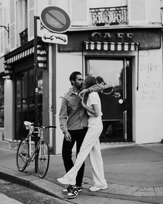 a man and woman walking down the street