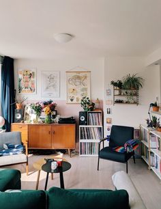 a living room filled with furniture and lots of books on top of a book shelf