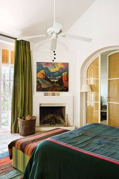 a bedroom with a bed, fireplace and sliding glass doors