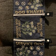 the service dog banner is hanging on the back of a couch with two tags attached to it