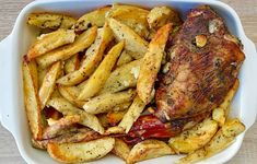 a white bowl filled with french fries and meat