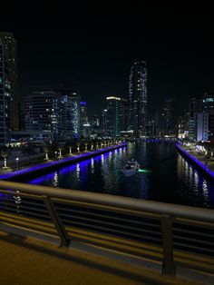 there is a boat that is going down the river in the city at night time