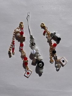 two pairs of earrings with charms attached to them