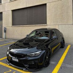 a black car parked in front of a building