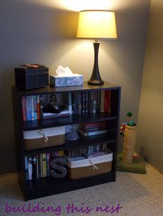 a book shelf with several books on it and a lamp in the corner next to it